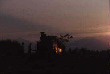 The sun sets over Colomadu 4, Gunung Merapi and Gunung Merbabu.